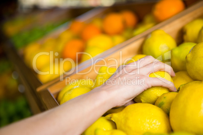 Close up view of a woman picking orange