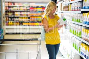 Woman taking a product in aisle
