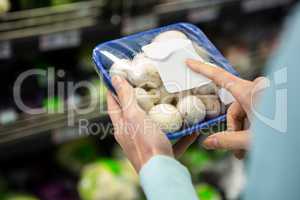 Mid section of a woman holding mushrooms