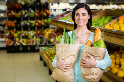 Smiling woman holding grocery bag