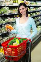 Smiling woman picking vegetables