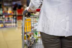 Cropped image of woman pushing trolley
