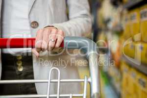 Cropped image of woman pushing trolley