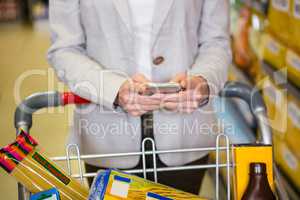 Woman using her smartphone in aisle