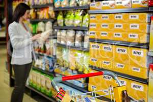Woman looking at product in aisle