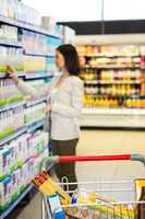 Woman looking at product in aisle