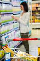 Woman looking at product in aisle