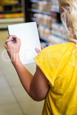Cropped image of woman checking list