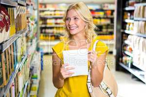 Smiling blond woman checking list