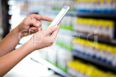 Cropped view of woman using her smartphone