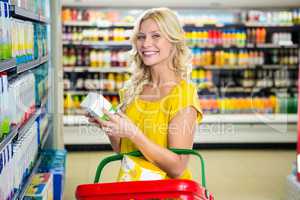 Blonde woman holding product