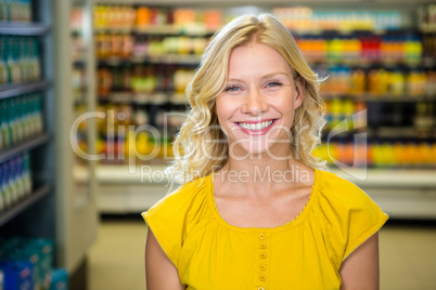 Portrait of smiling woman standing in aisle