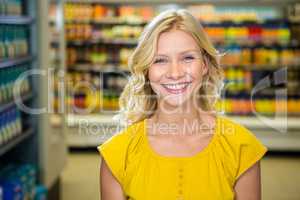 Portrait of smiling woman standing in aisle