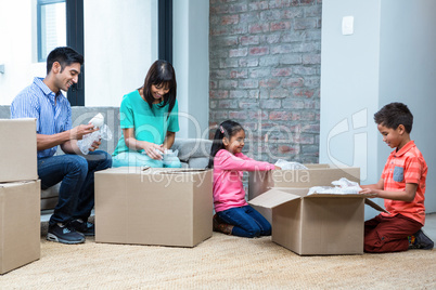 Happy family opening boxes