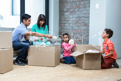 Happy family opening boxes