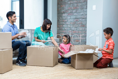 Happy family opening boxes