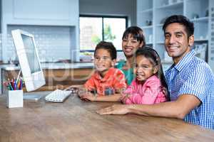 Happy family using computer in the kitchen