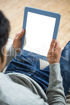 Handsome man using tablet on the sofa