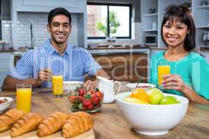Happy couple having breakfast