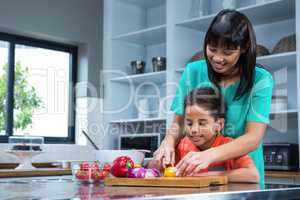 Smiling mother cooking with her son