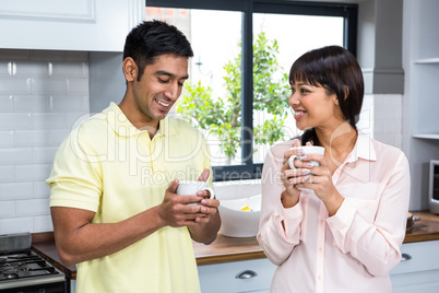 Happy coupletalking and holding cups