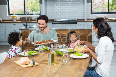 Happy family eating together in the kitchen