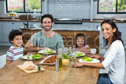 Happy family eating together in the kitchen