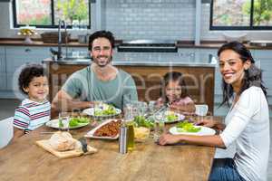 Happy family eating together in the kitchen