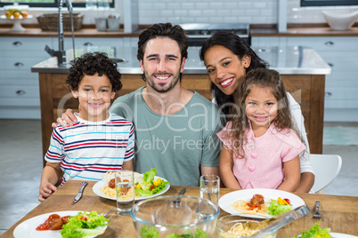 Happy family eating together in the kitchen