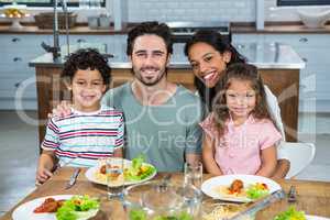 Happy family eating together in the kitchen