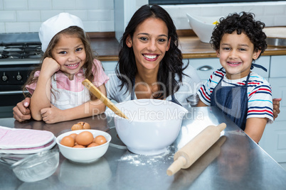 Smiling mother in the kitchen with her children