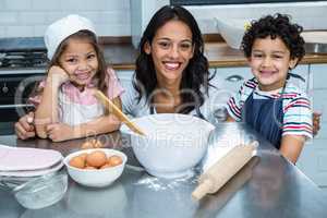 Smiling mother in the kitchen with her children