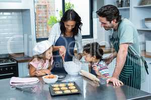 Happy family cooking biscuits together