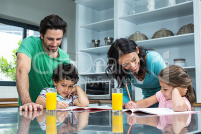 Parents helping their children doing homework