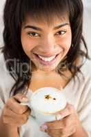 Smiling woman drinking a coffee