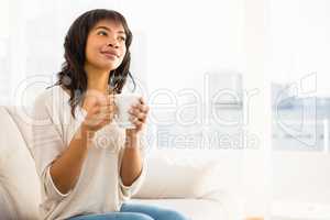 Smiling woman drinking a coffee