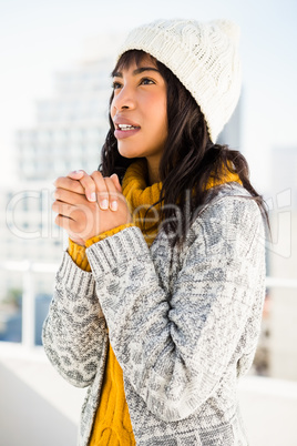 Smiling woman wearing winter clothes and looking otherwise