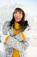 Smiling woman wearing winter clothes with arms crossed