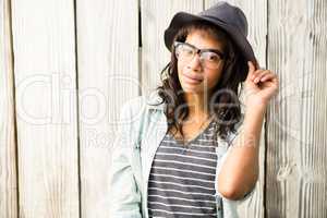 Smiling casual woman posing with glasses and hat