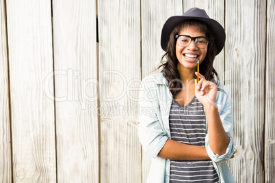 Smiling casual woman posing with glasses and hat