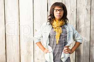 Smiling casual woman posing with glasses and hands on hips