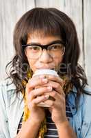 Smiling casual woman posing with glasses while drinking coffee