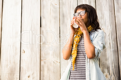 Smiling casual woman posing with glasses while drinking coffee