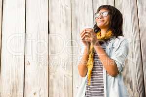 Smiling casual woman posing with glasses while drinking coffee