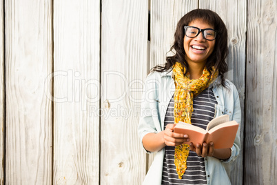 Smiling casual woman reading a book