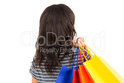 Rear view of a casual woman holding shopping bags