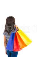 Rear view of a casual woman holding shopping bags