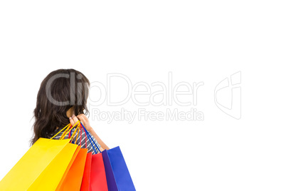 Rear view of a casual woman holding shopping bags