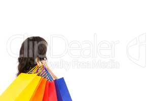Rear view of a casual woman holding shopping bags