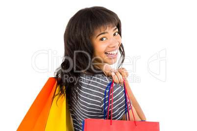 Rear view of a casual woman holding shopping bags